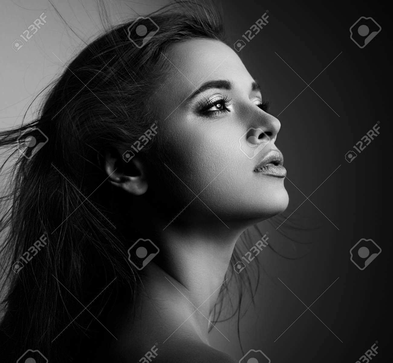 Beautiful mystic woman profile with long hair looking black and white portrait closeup stock