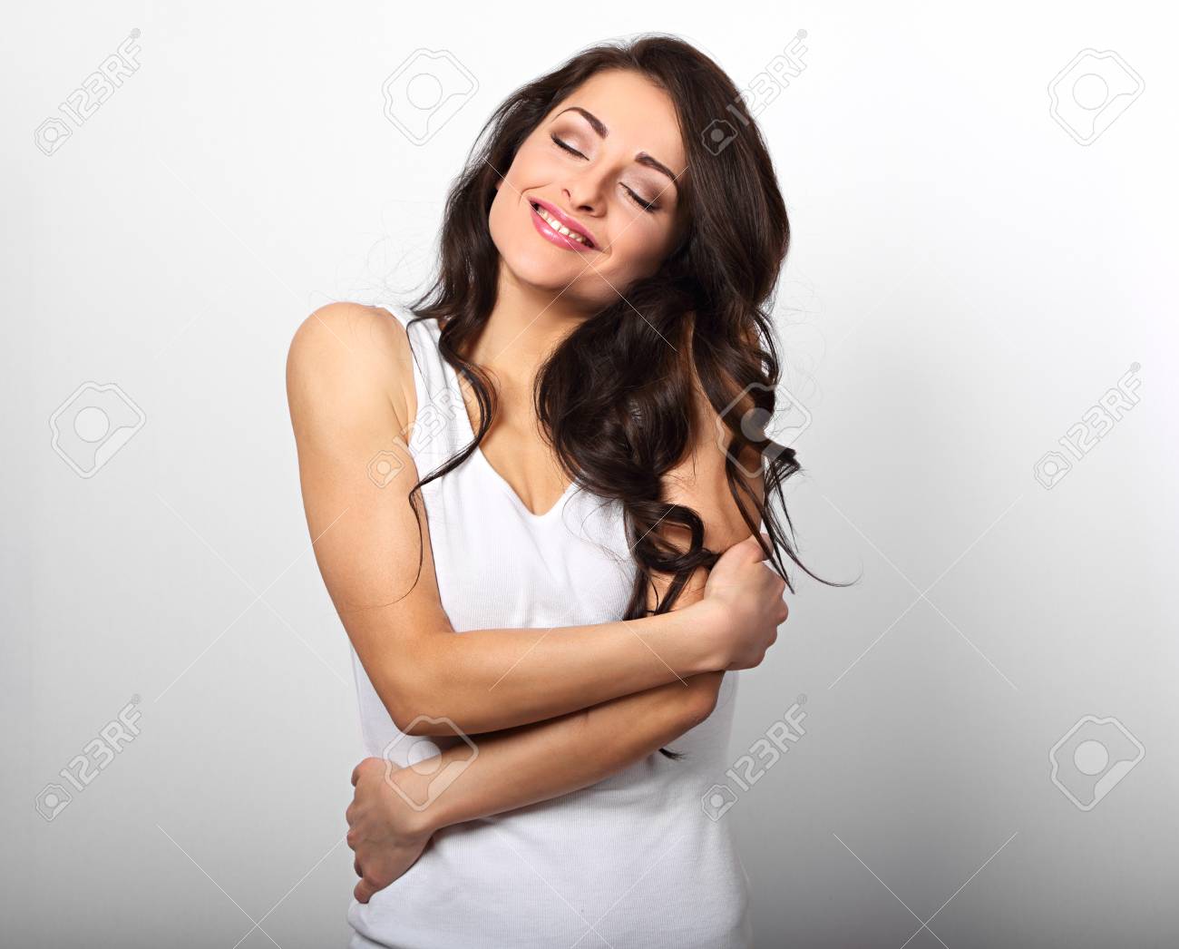 白い背景に自然な感情的な楽しみ顔で自分自身を抱きしめる幸せなスポーティな女性 自分の体の愛の概念 の写真素材 画像素材 Image