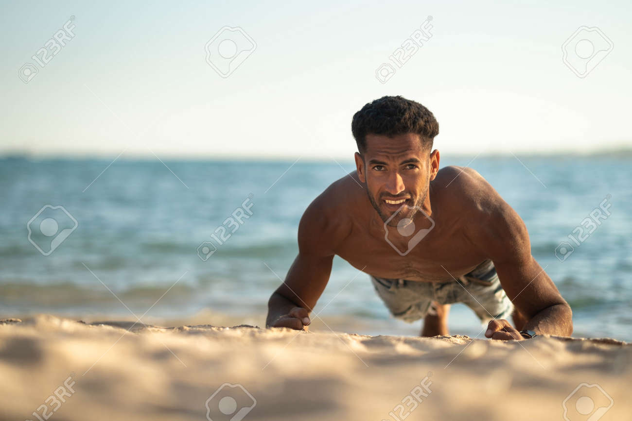 Handsome And Confident, Outdoor Smiling Portrait Of Relaxing Young African Egyptian  Man Traveler On The Beach. Stock Photo, Picture and Royalty Free Image.  Image 190881797., image size:1300x867
