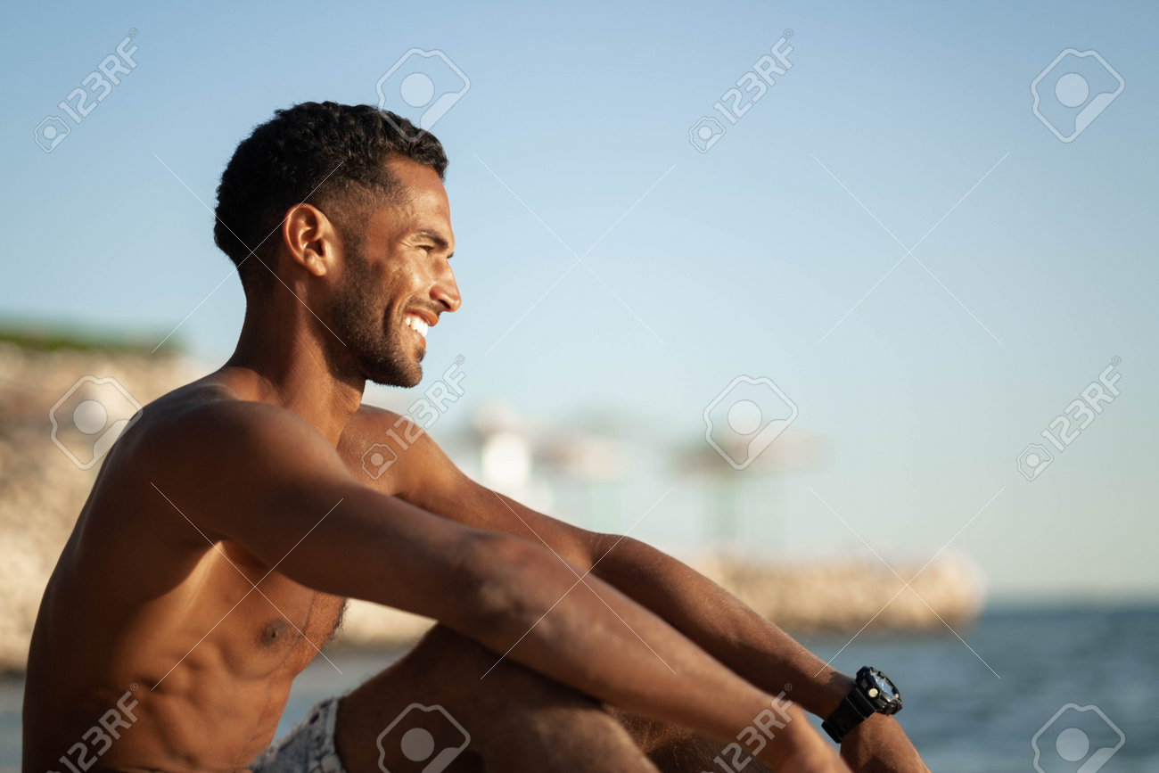 Handsome And Confident, Outdoor Smiling Portrait Of Relaxing Young African Egyptian  Man Traveler On The Beach. Stock Photo, Picture and Royalty Free Image.  Image 192773287., image size:1300x867