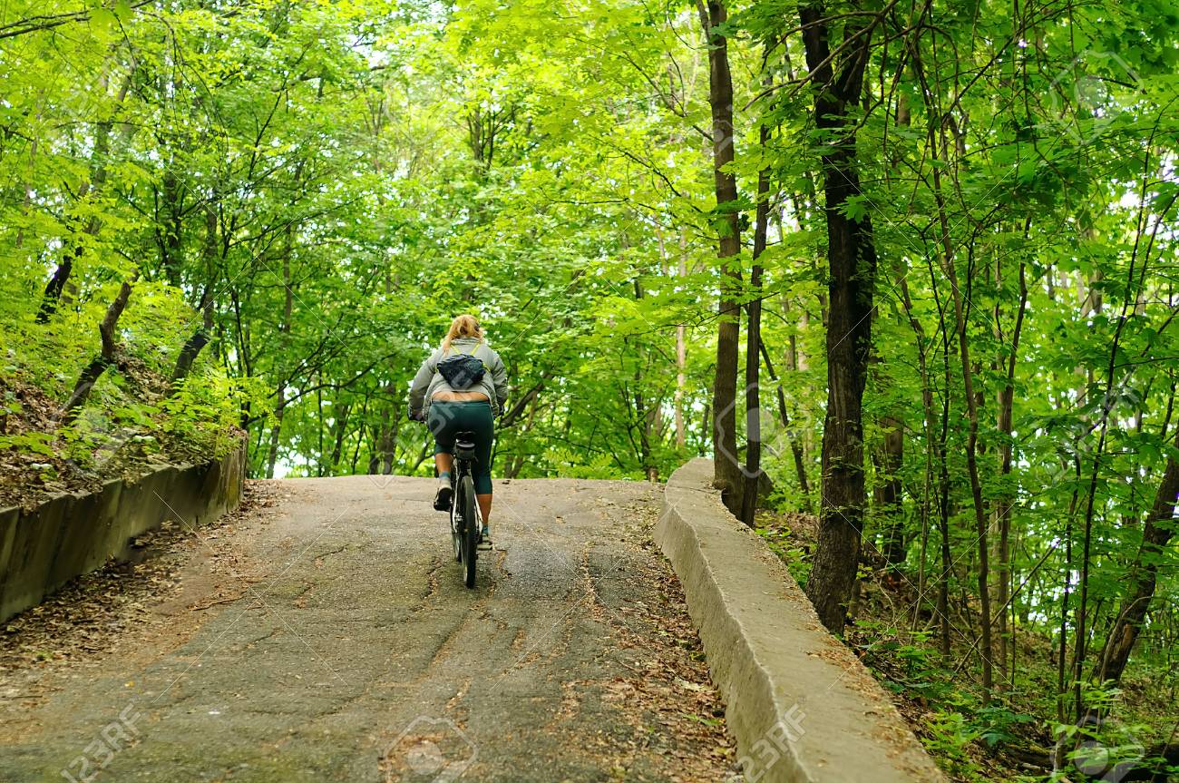 young girl on a bicycle on steep path sport concept biking in a