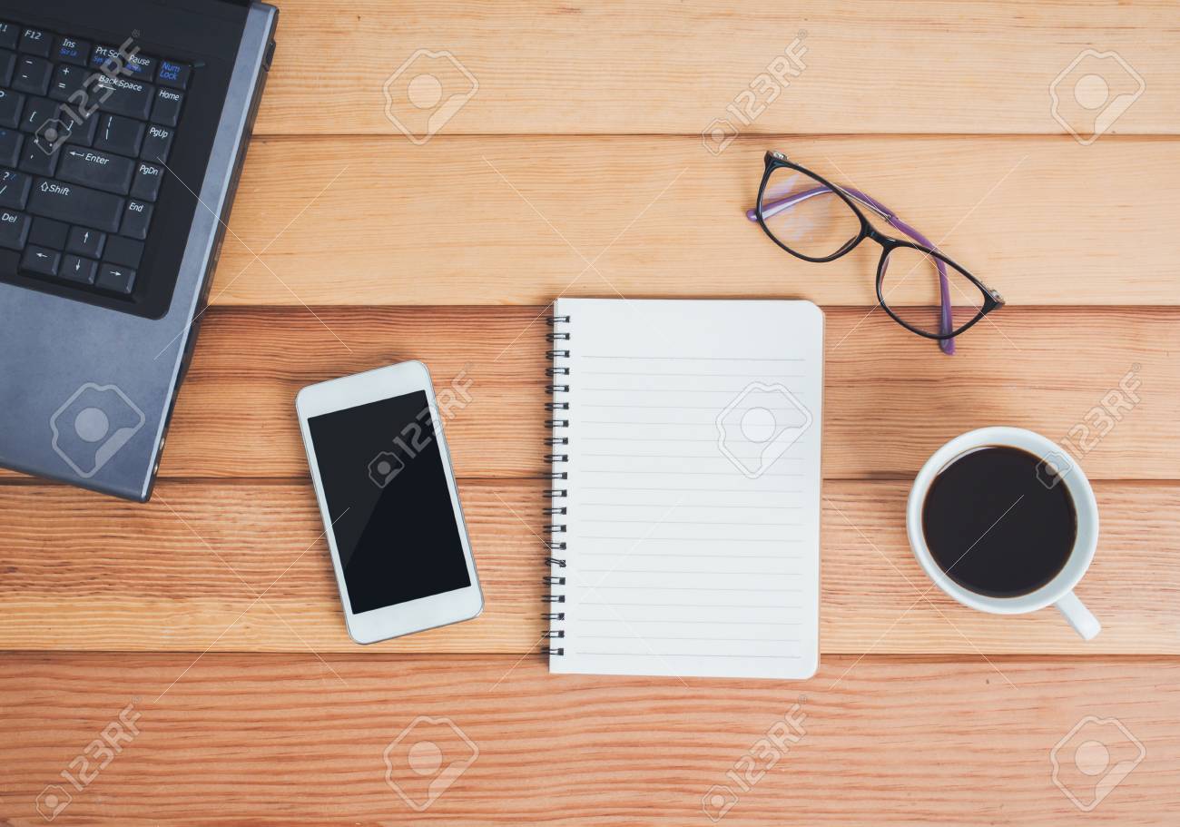 Top View Of Office Desk Table With Laptop,smartphone,notebook,eyeglasses  And Cup Of Coffee. Stock Photo, Picture and Royalty Free Image. Image  96921301., image size:1300x911