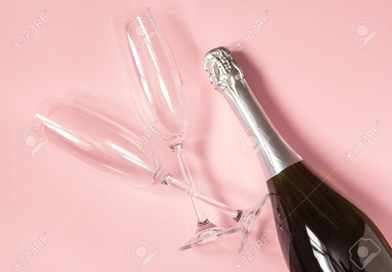 Champagne Bottle And Two Empty Champagne Glasses On Pink Background In  Pastel Colors. Birthday Party, Wedding, Valentine's Day. Top View. Vintage  Style. Stock Photo, Picture and Royalty Free Image. Image 98921552., image size:1300x902