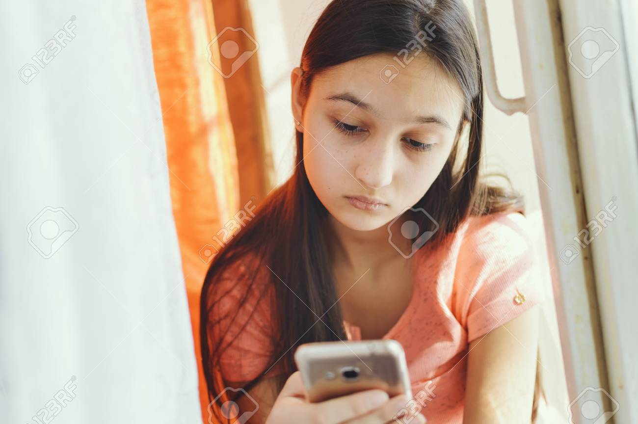 Beautiful Teen Girl Holding A Mobile Phone Lifestyle Style Stock Photo Picture And Royalty Free Image Image