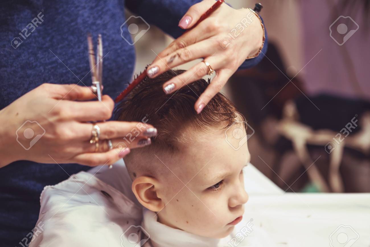 Little Boy At The Hairdresser Child Is Scared Of Haircuts Hairdresser S