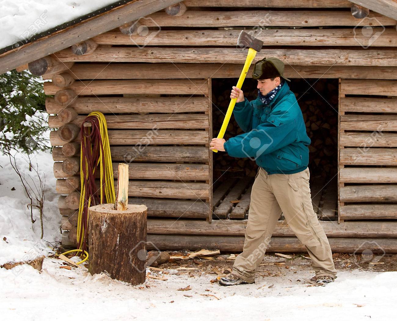 man cutting wood with