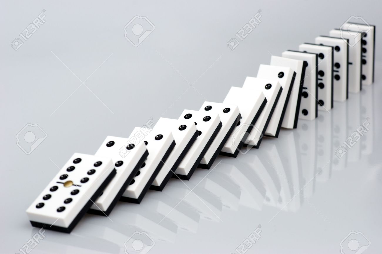 Dominos Falling Down In Chain Reaction Stock Photo, Picture and Royalty  Free Image. Image 3917735.