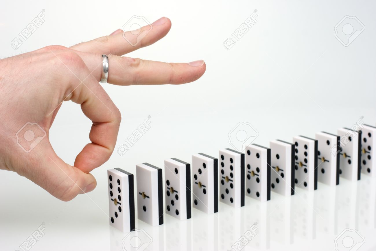 Hand Ready To Start Domino Chain Reaction Stock Photo, Picture and Royalty  Free Image. Image 3950485.