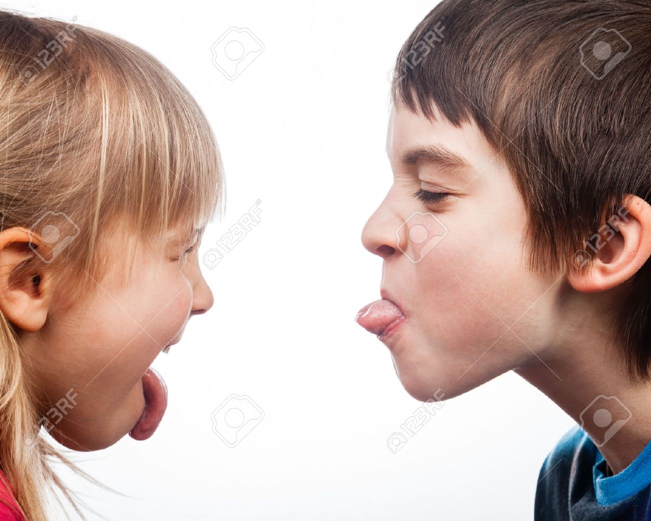 Close-up shot of boy and girl sticking out tongues to each other on white background. Children are half-siblings. - 38791925 Close-up shot of boy and girl sticking out tongues to each other on white background. Children are half-siblings. - 38791925