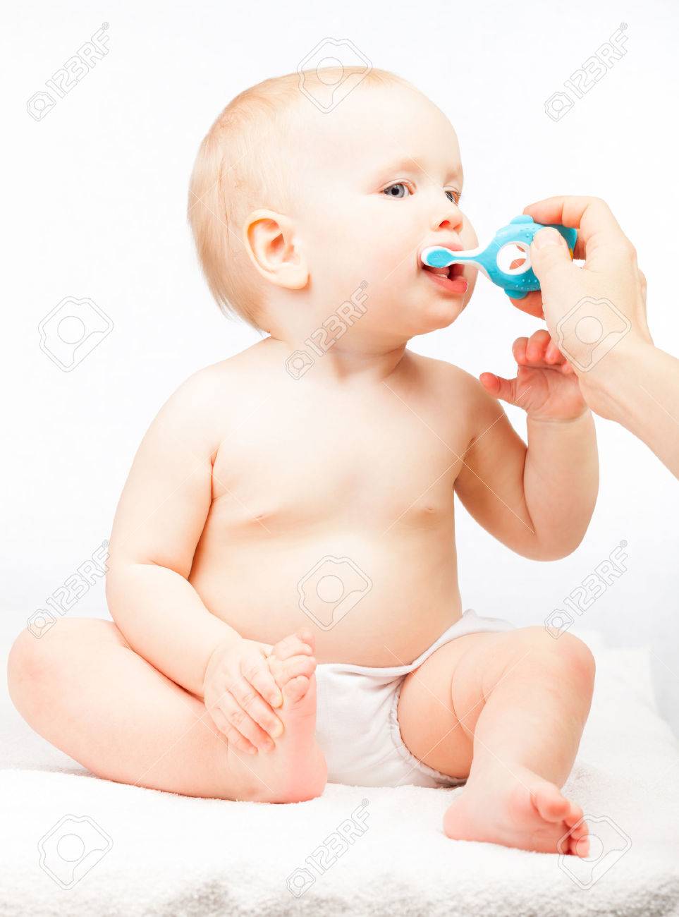 Little baby girl learning to brush teeth with mother's help - 51086267 Little baby girl learning to brush teeth with mother's help - 51086267