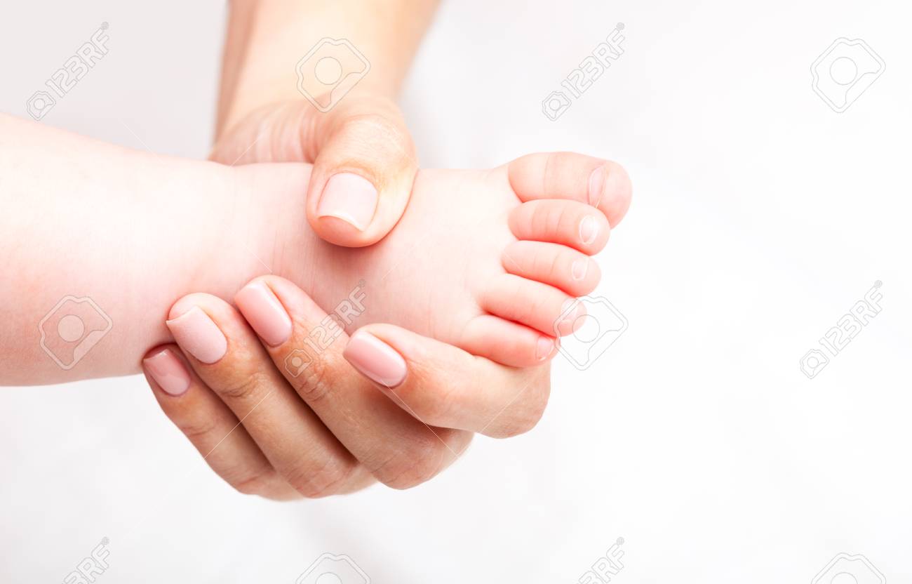 Seven month baby girls foot joint being manipulated by osteopathic manual therapist or physician - 82242038 Seven month baby girls foot joint being manipulated by osteopathic manual therapist or physician - 82242038
