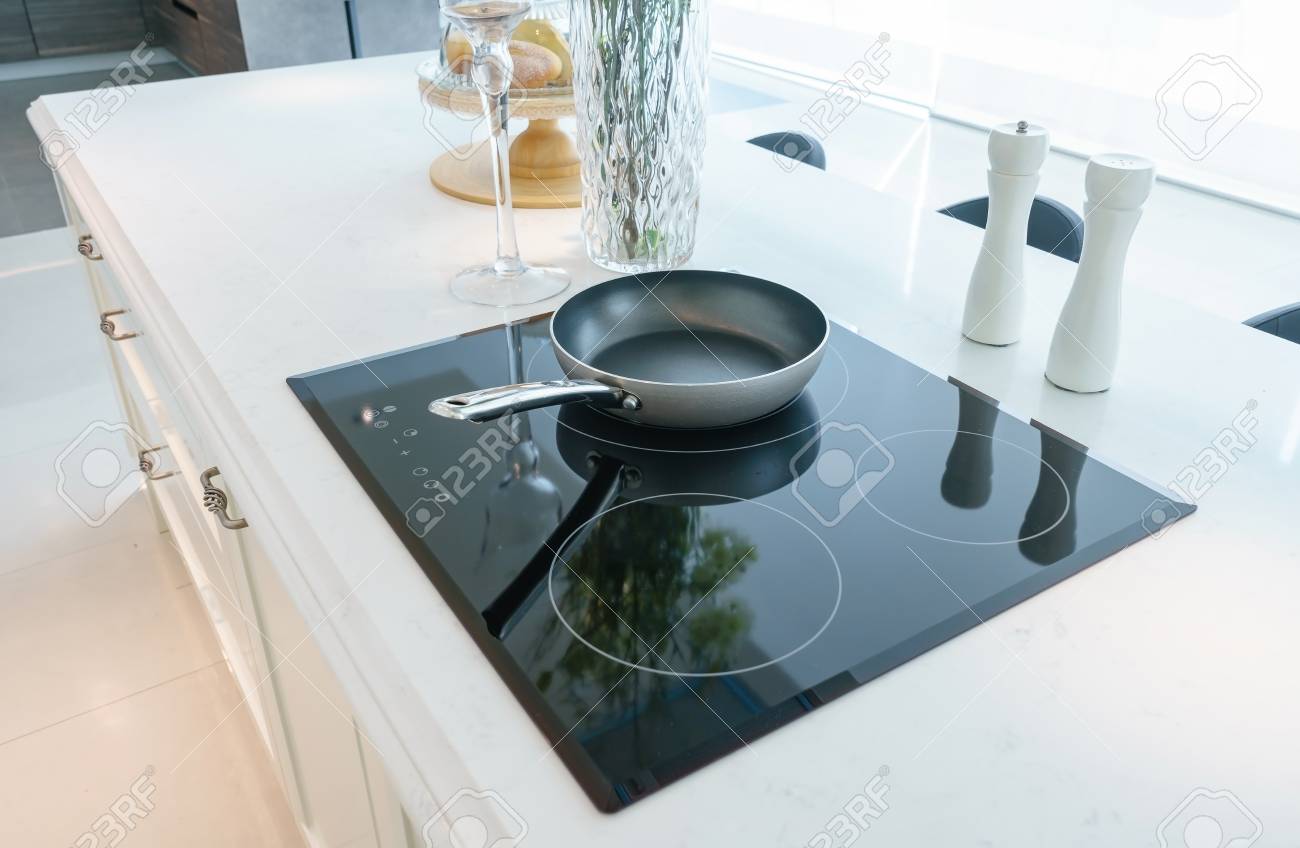 Frying Pan On Modern Black Induction Stove Cooker Hob Or Built