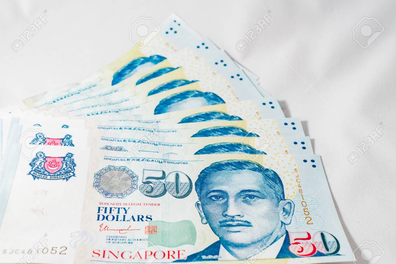 Singapore Dollar, Banknote Singapore On White Background, The Singapore  Dollar Is The Official Currency Of Singapore Stock Photo, Picture and  Royalty Free Image. Image 97005238.
