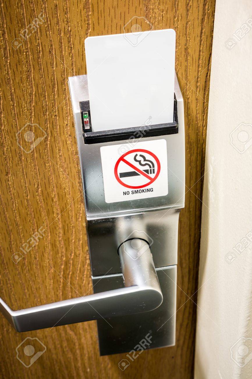 No Smoking Sign On A Hotel Room Electronic Door Lock With A Key