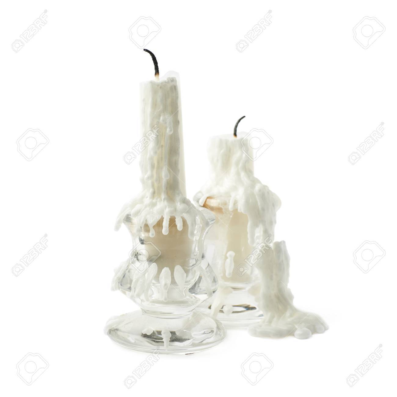 composition of two burnt white candles in a candlestick isolated