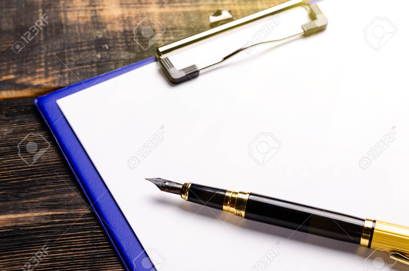 Blank Paper With Pen In Folder On Wooden Table In Studio Stock