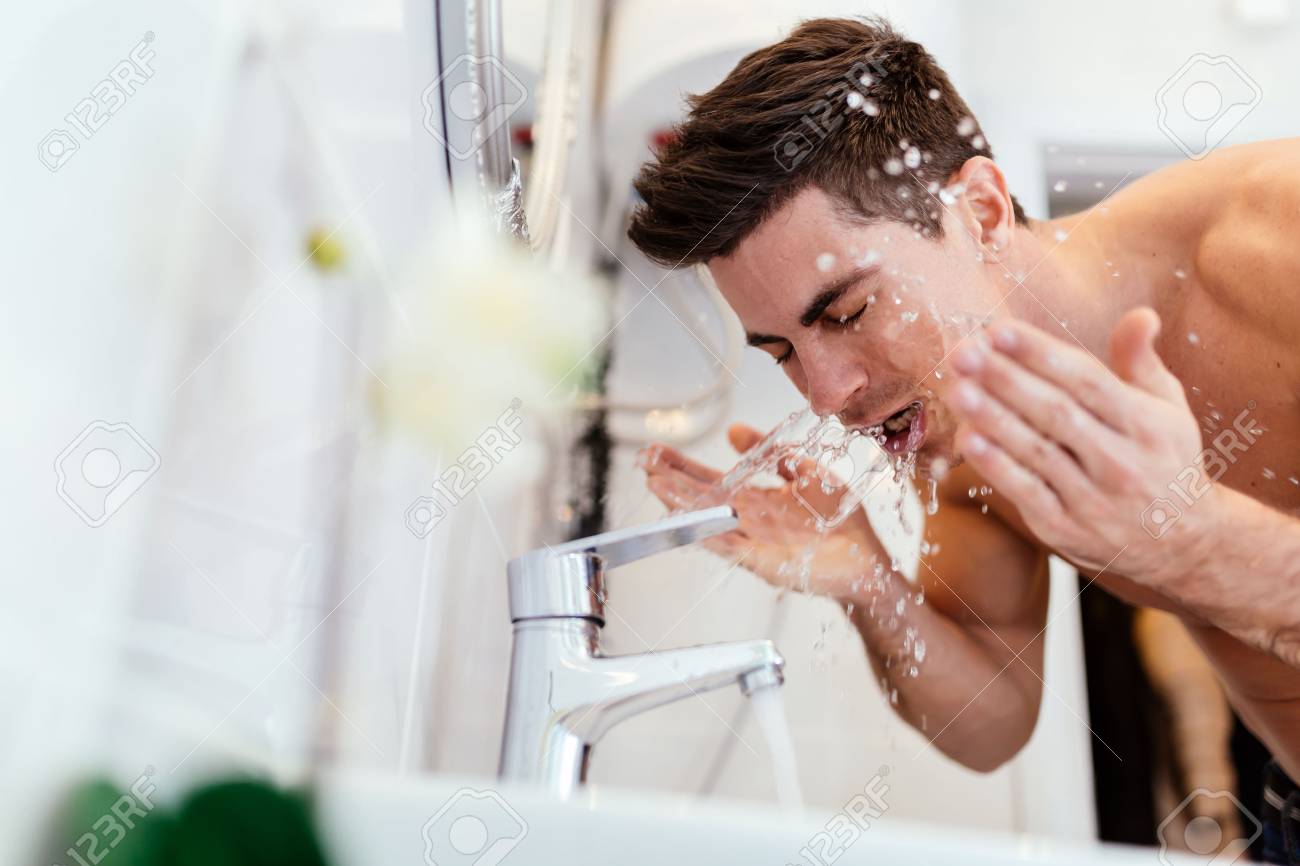 man washing face