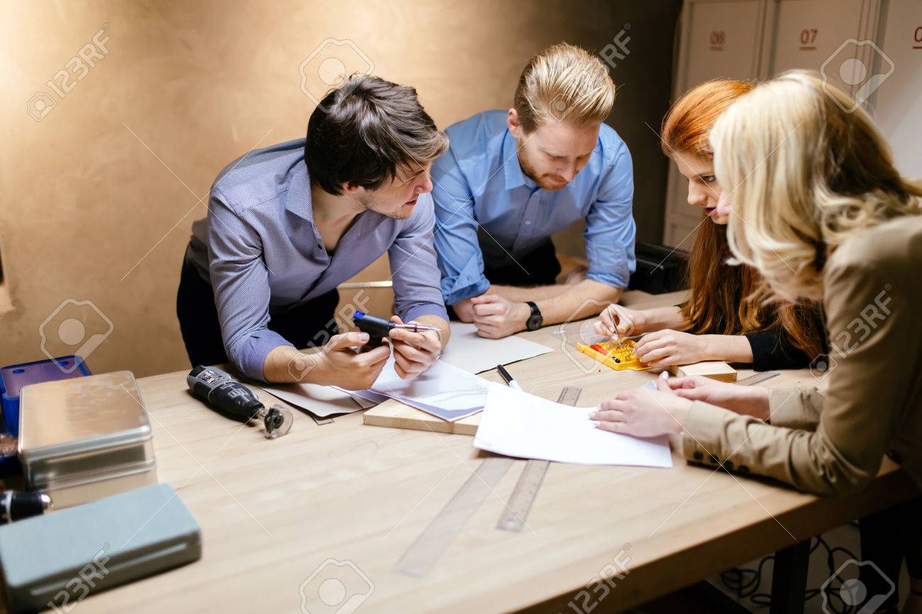 Group of designer working on project in workshop - 57623786 Group of designer working on project in workshop - 57623786