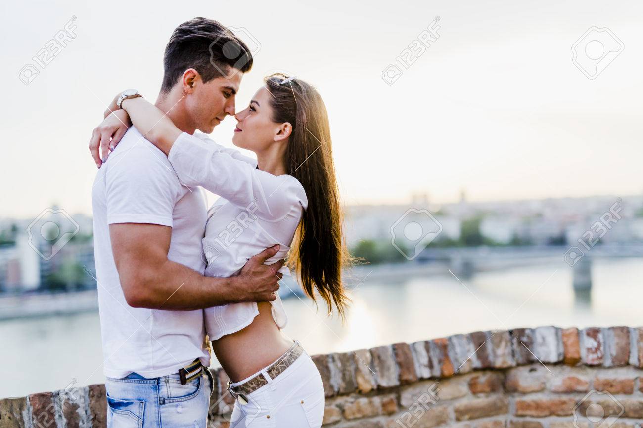 Young Romantic Couple Hugging And About To Kiss In Beautiful Sunset Stock Photo Picture And Royalty Free Image Image 66466311