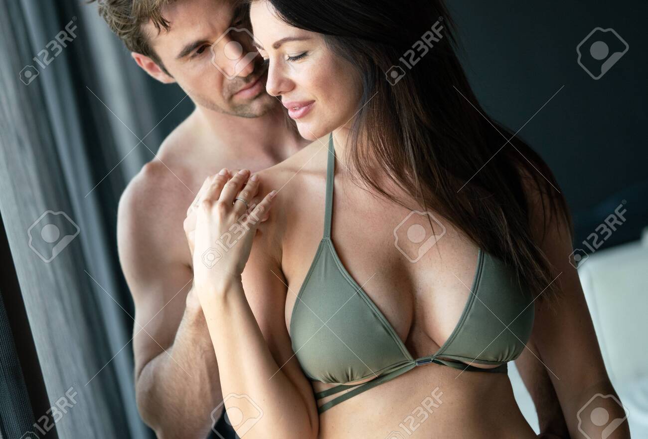 Young Happy Sexy Couple Relaxing In Love At Home Stock Photo, Picture and  Royalty Free Image. Image 154859130.