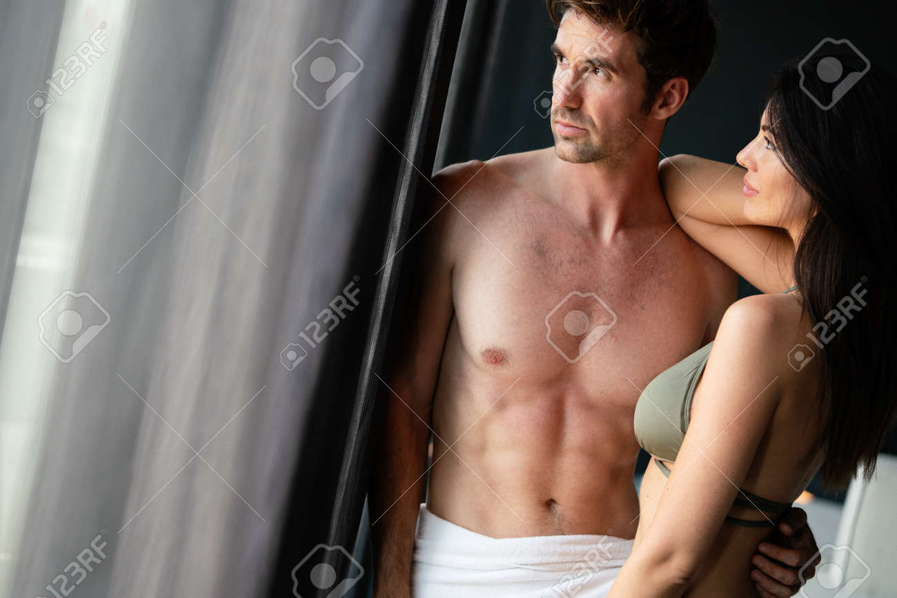 Young Happy Sexy Couple Relaxing In Love At Home Stock Photo, Picture and  Royalty Free Image. Image 165699935.