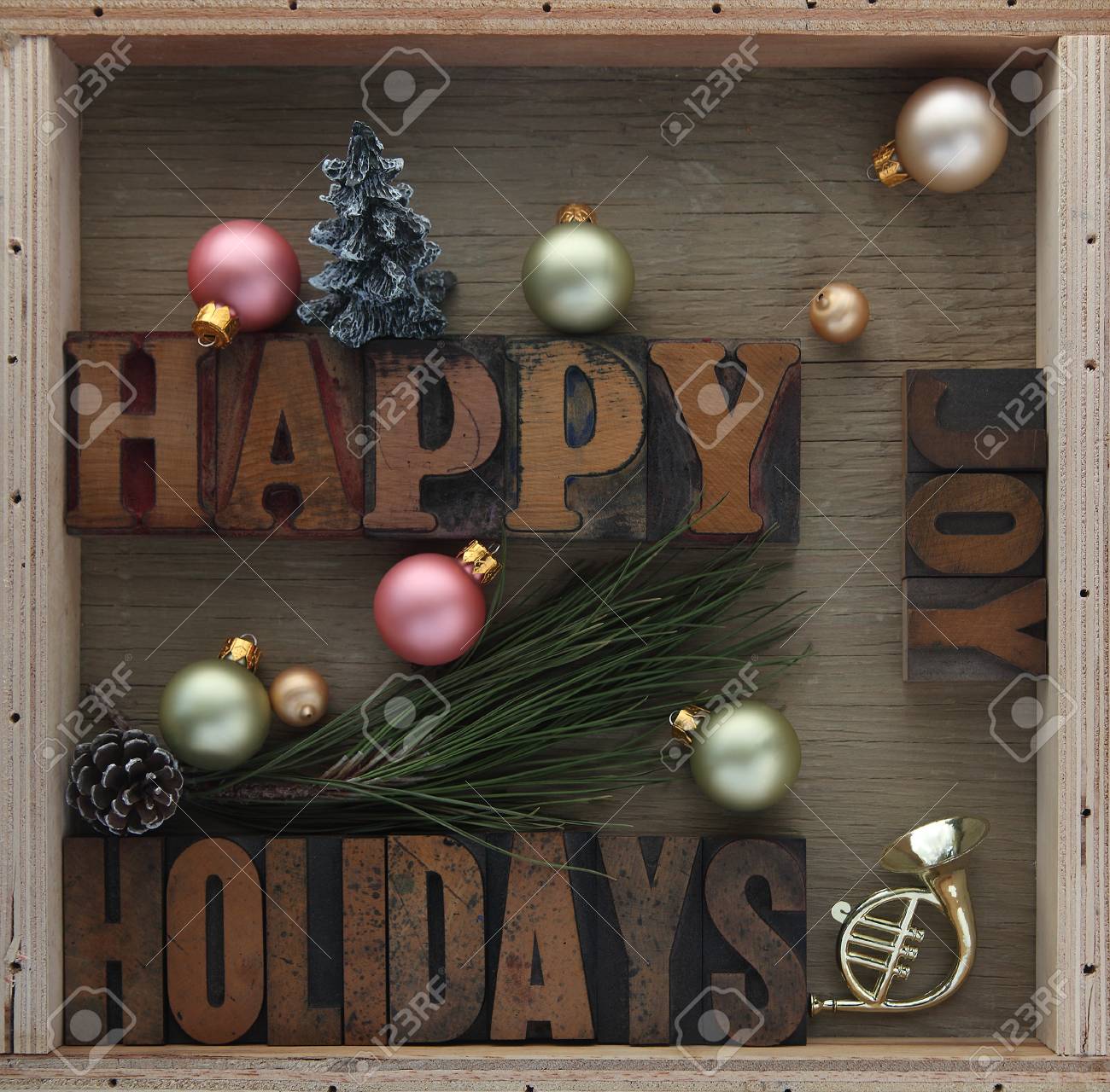 happy holidays words with ornaments pine cone toy horn and stock
