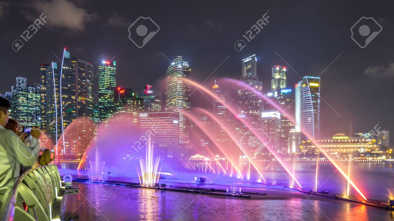 light and water show along promenade in front of marina bay sands