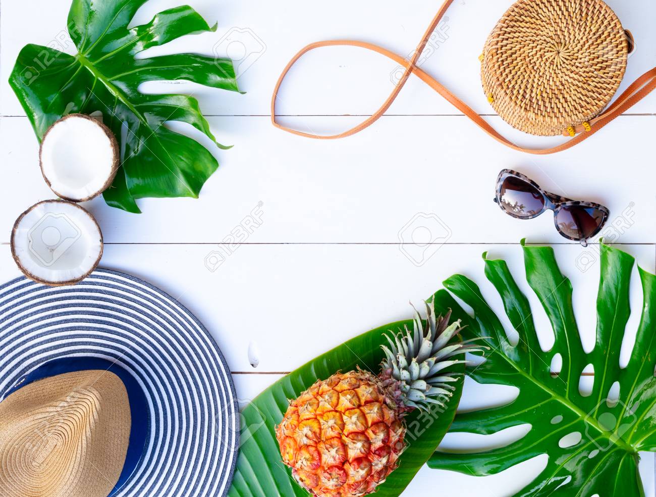 Summer flat lay frame with hat, bag, leaves and fruits on white background with copy space - 120867428 Summer flat lay frame with hat, bag, leaves and fruits on white background with copy space - 120867428