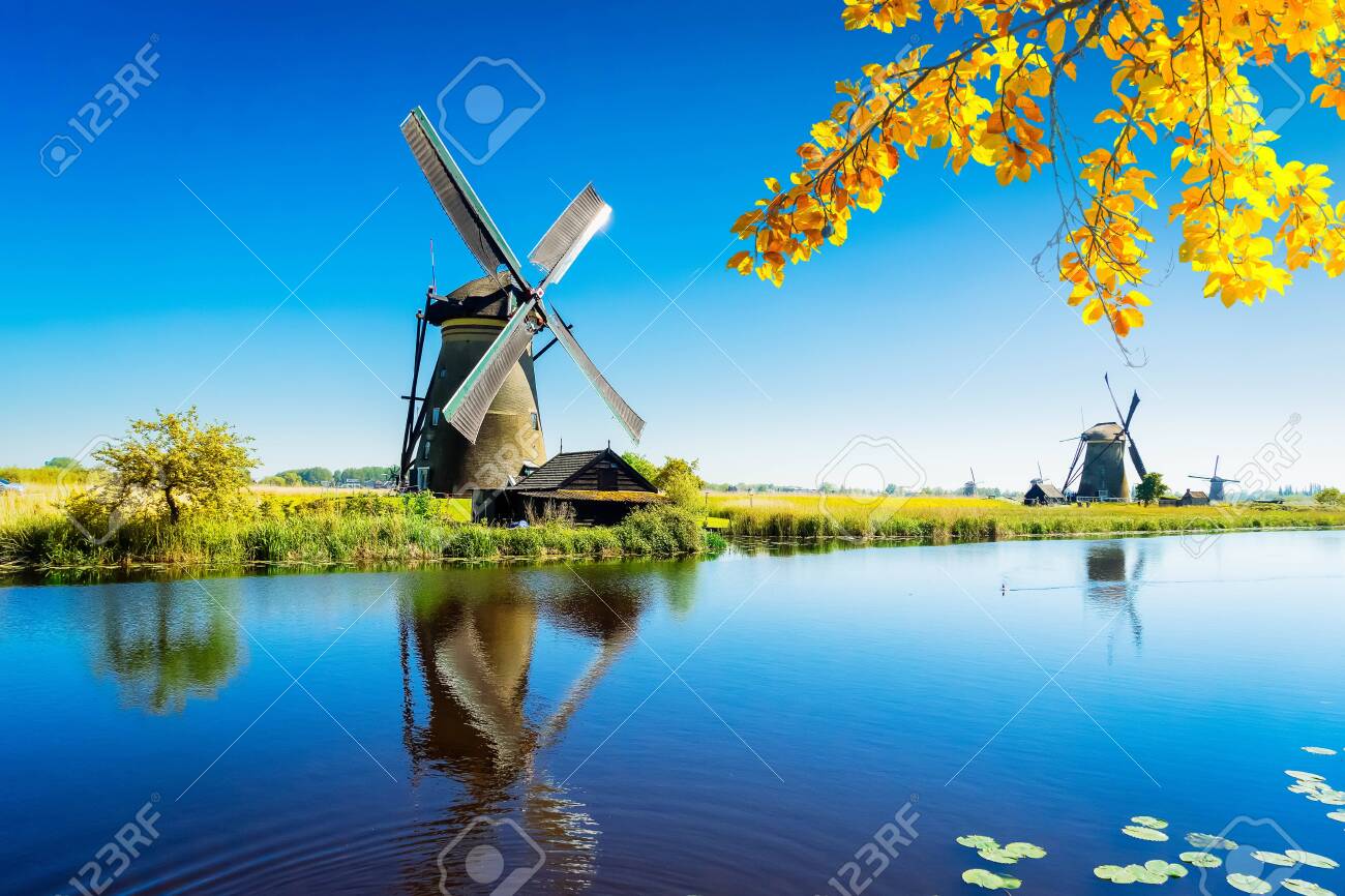 traditional dutch windmill with reflection at water, Kinderdijk at fall day, Netherland - 131811820 traditional dutch windmill with reflection at water, Kinderdijk at fall day, Netherland - 131811820
