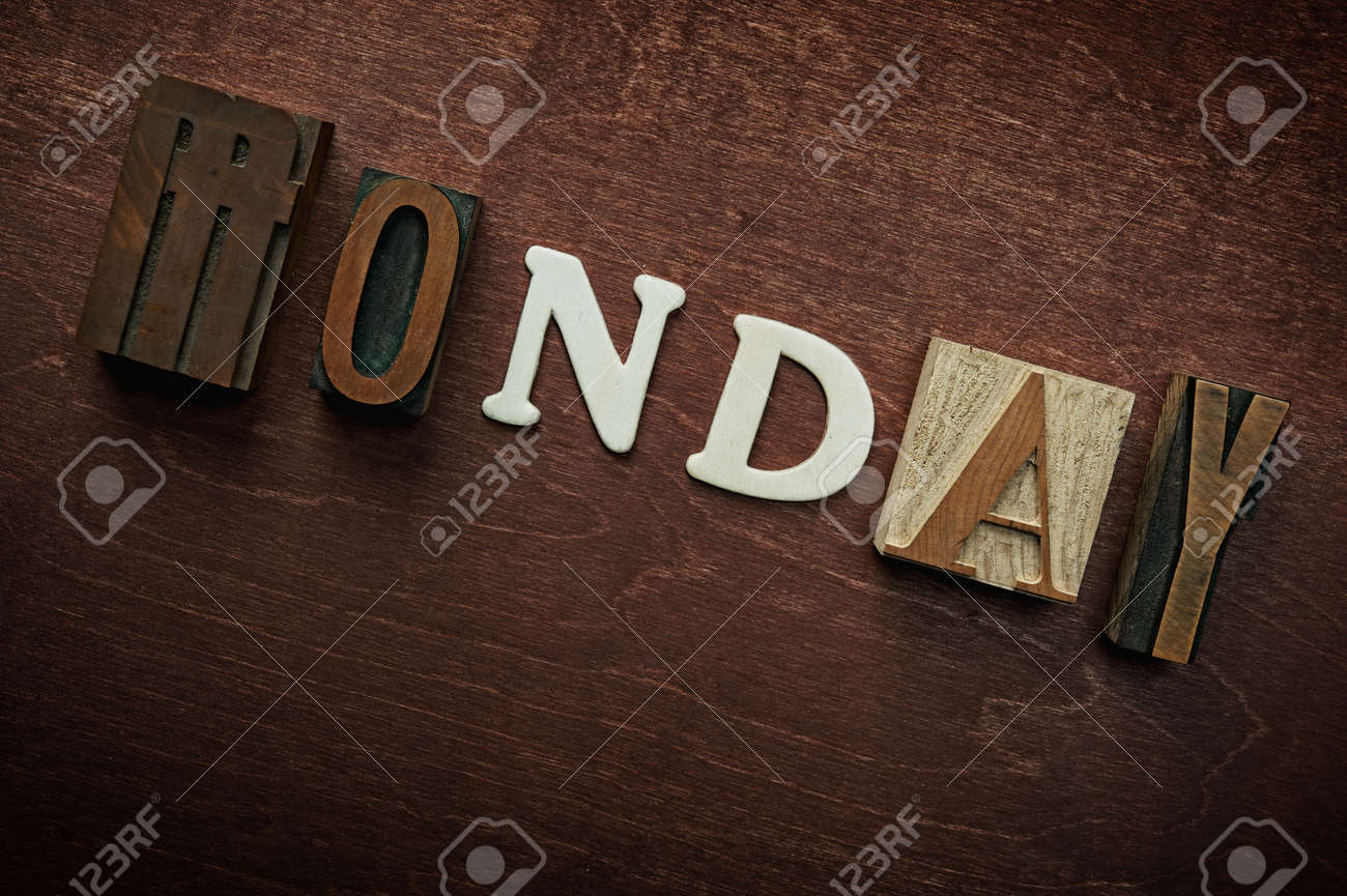 the word monday written on wooden background stock photo picture the word monday