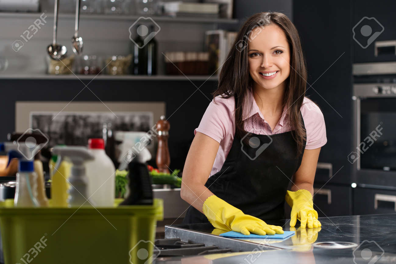 Beautiful cheerful brunette woman in gloves cleaning modern kitchen - 24718810 Beautiful cheerful brunette woman in gloves cleaning modern kitchen - 24718810