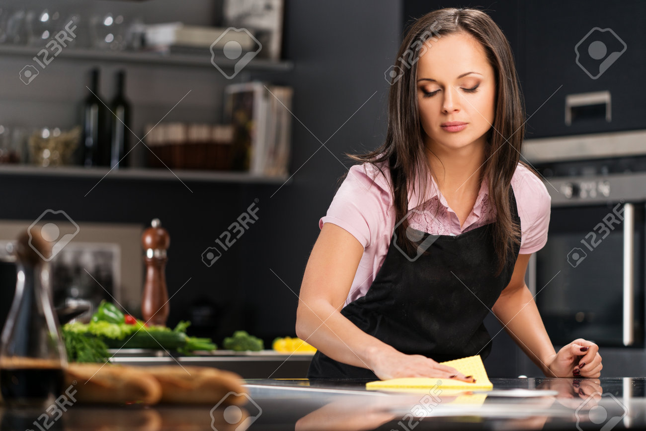 Young cheerful woman cleaning modern kitchen - 25395365 Young cheerful woman cleaning modern kitchen - 25395365