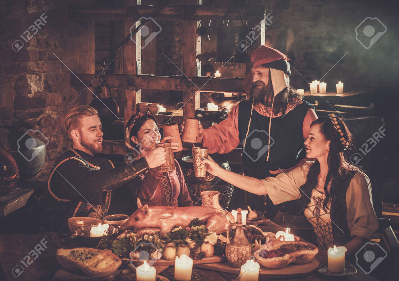 Medieval people eat and drink in ancient castle tavern. - 94536888 Medieval people eat and drink in ancient castle tavern. - 94536888