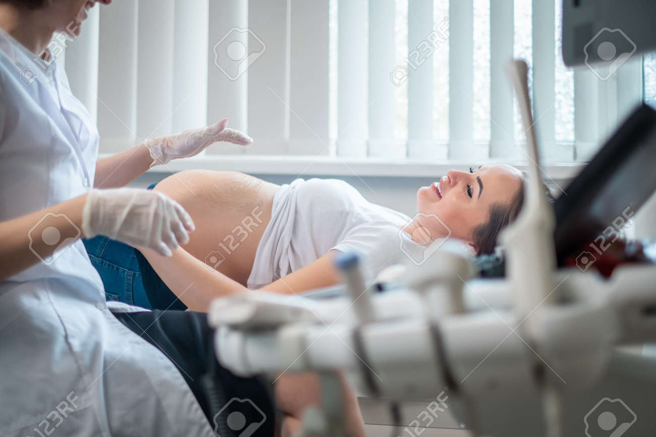 Pregnant woman on utltrasonographic examination at hospital - 129251520 Pregnant woman on utltrasonographic examination at hospital - 129251520