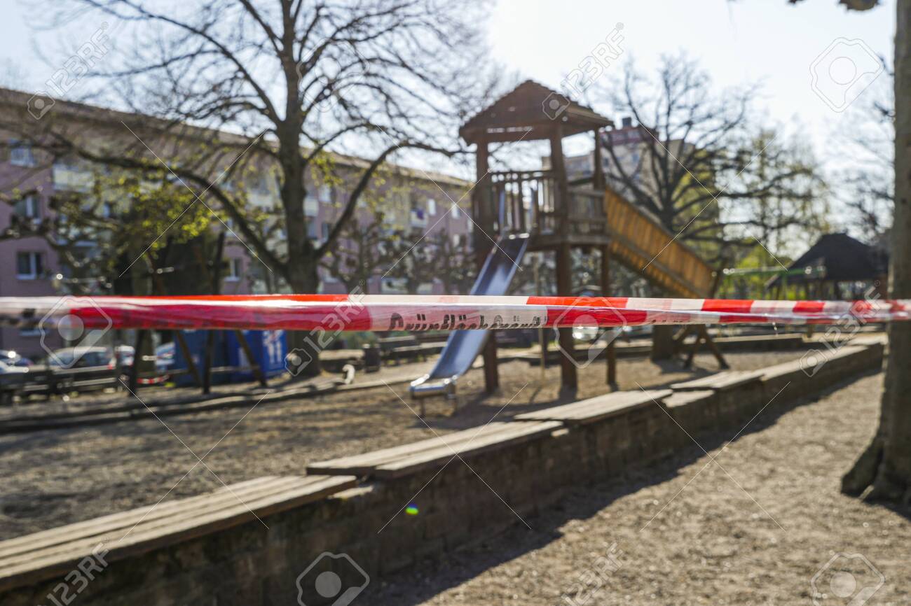 Children's playground with barricade tape preventing access during covid-19 quarantine. Focus on foreground. - 145067119 Children's playground with barricade tape preventing access during covid-19 quarantine. Focus on foreground. - 145067119