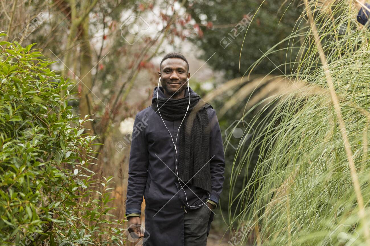 Portrait of Handsome Black Man Smiling in Autumn Foliage - 146783205 Portrait of Handsome Black Man Smiling in Autumn Foliage - 146783205