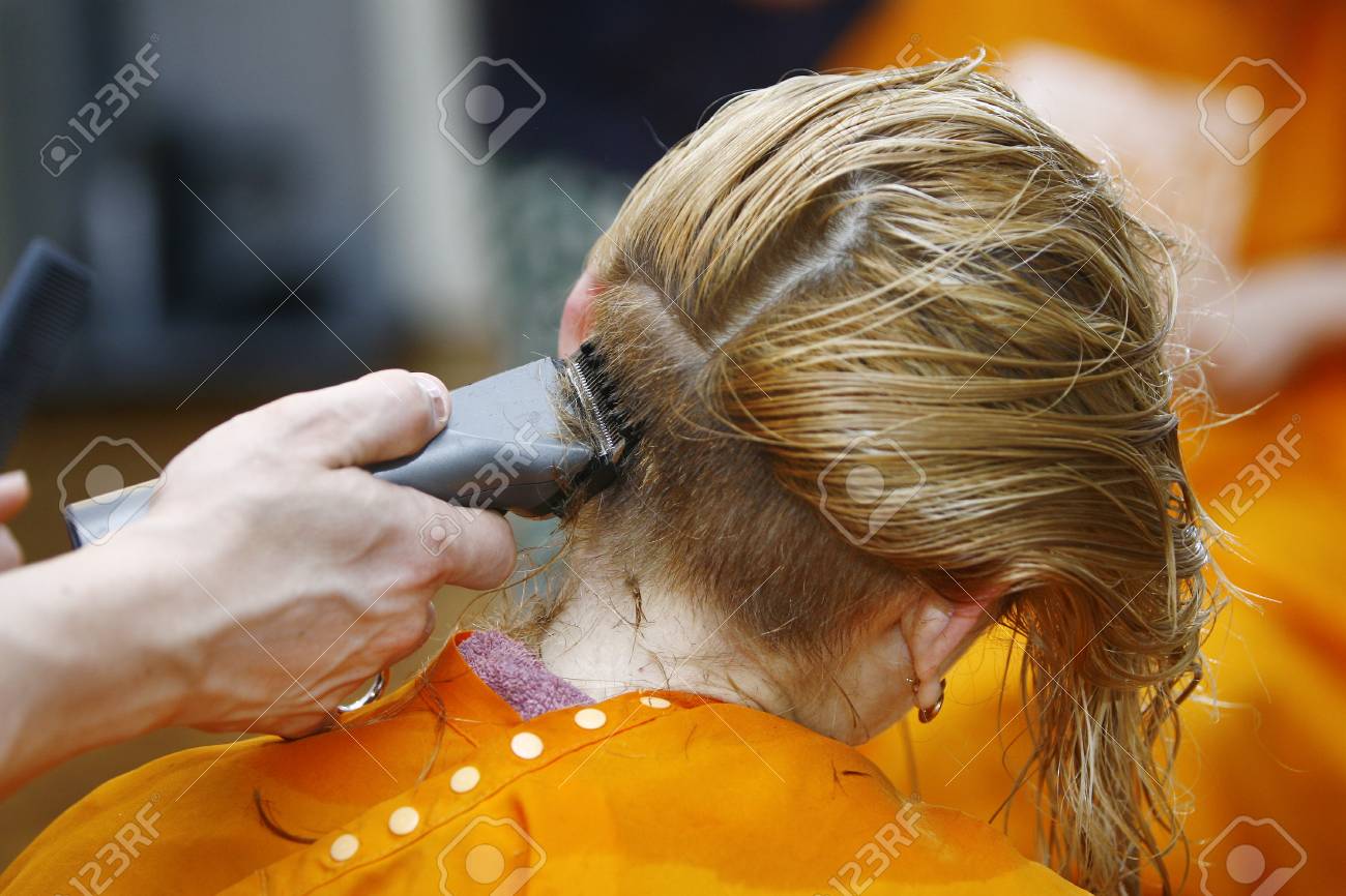Blonde Haircut At The Salon With Hair Trimmer For Short Hair Stock