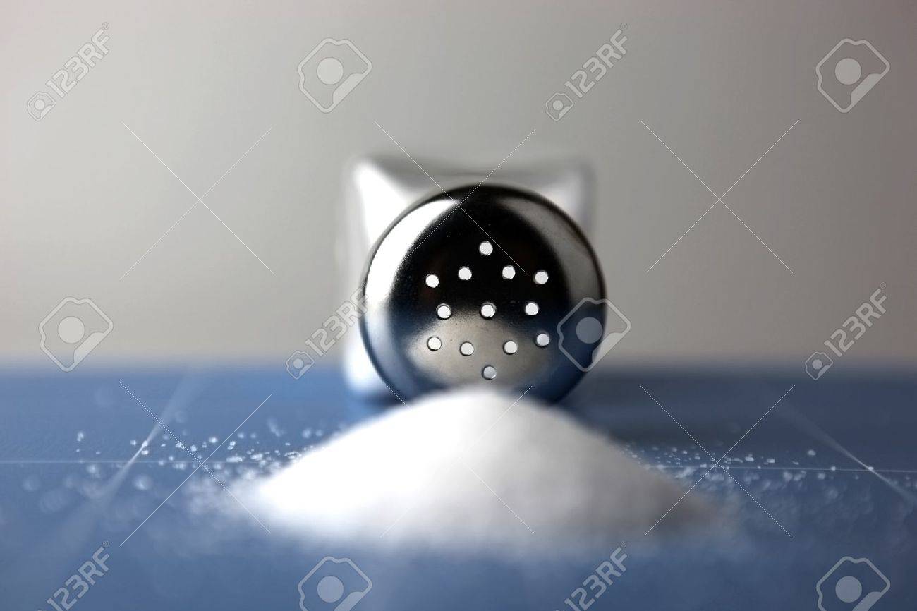 Glass saltcellar with salt on blue background - 8563190 Glass saltcellar with salt on blue background - 8563190