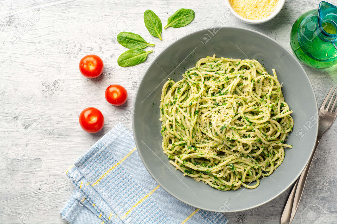 Spaghetti pasta with spinach sauce and parmesan cheese - 169457257 Spaghetti pasta with spinach sauce and parmesan cheese - 169457257
