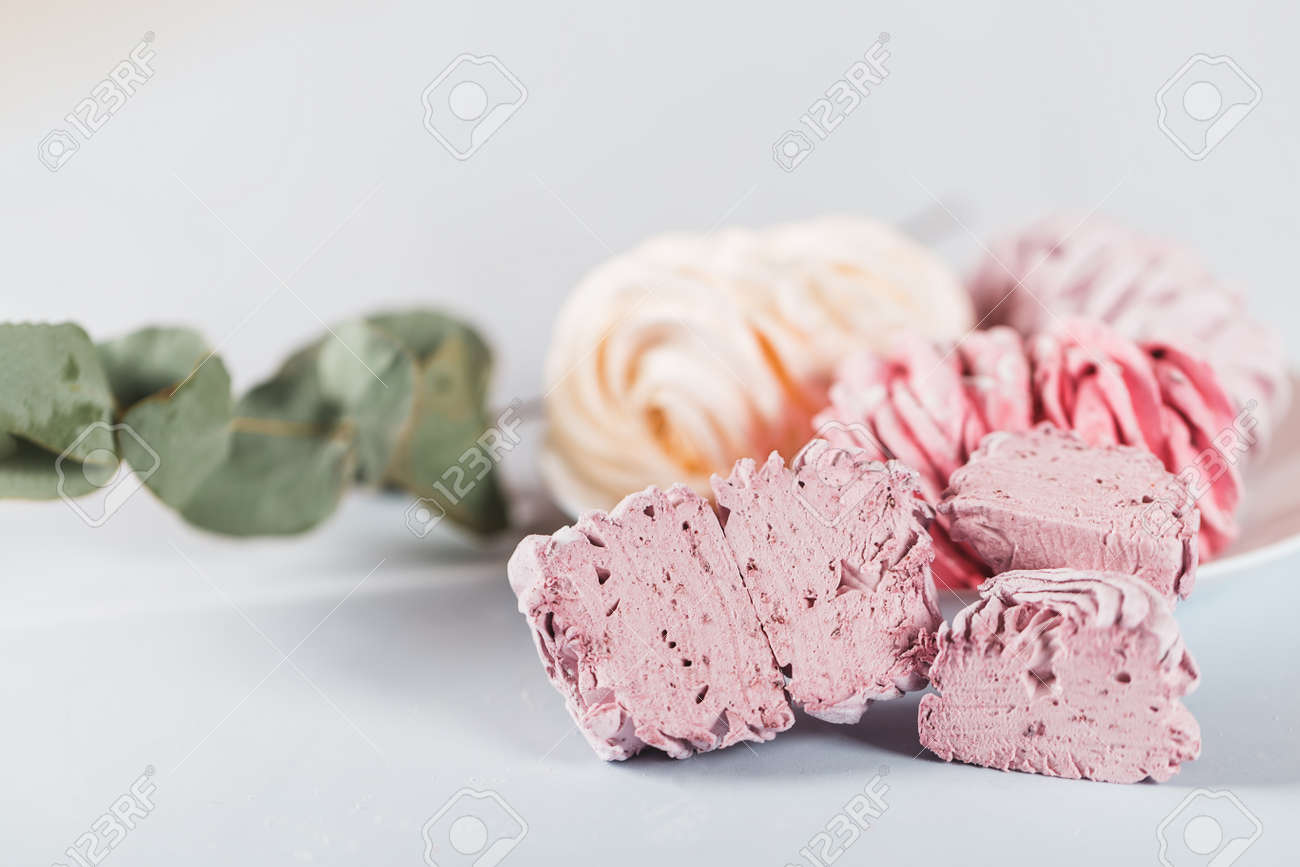 Appetizing multi-colored zephyr on a plate against a white background. Tea drinking concept. Confectionery decoration. Place for text. - 169602967 Appetizing multi-colored zephyr on a plate against a white background. Tea drinking concept. Confectionery decoration. Place for text. - 169602967