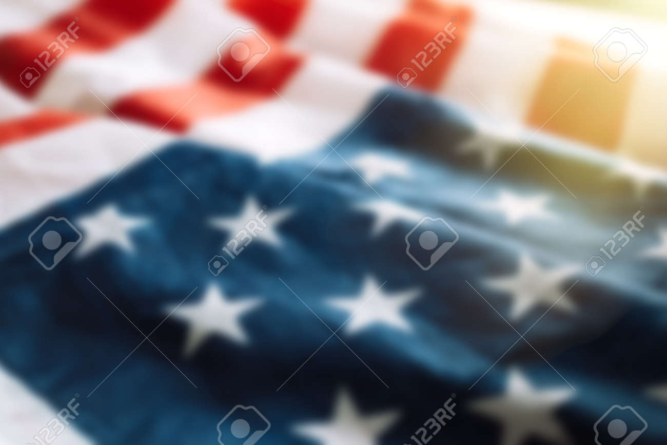 Blurred american flag background with sunlight. Fourth july concept. - 169694073 Blurred american flag background with sunlight. Fourth july concept. - 169694073