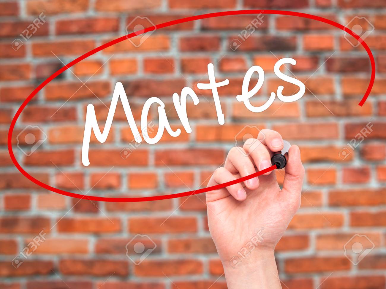 Man Hand Writing Martes (Tuesday In Spanish) With Black Marker On