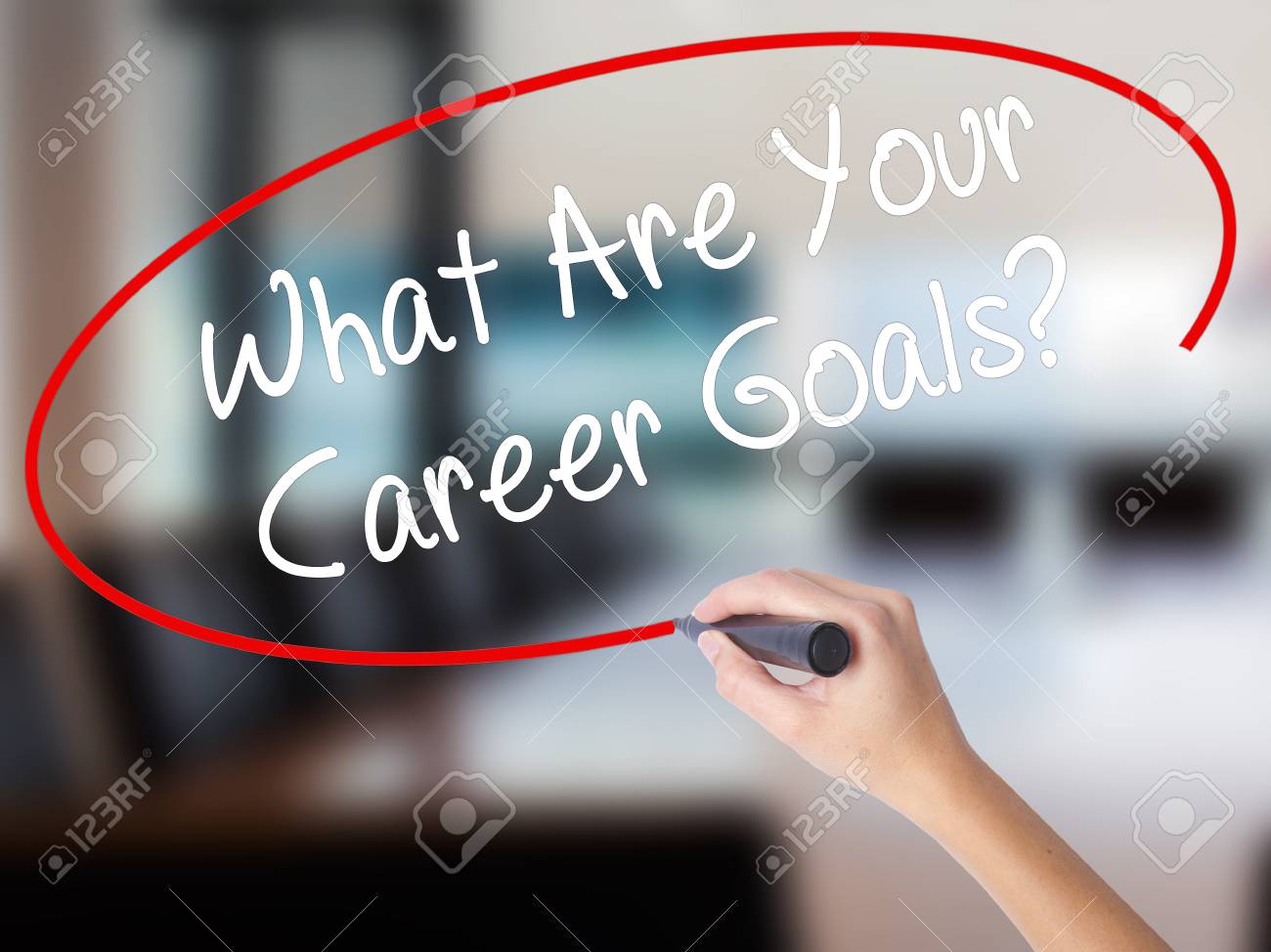 stock photo woman hand writing what are your career goals with a marker over transparent board isolated on office business concept stock photo