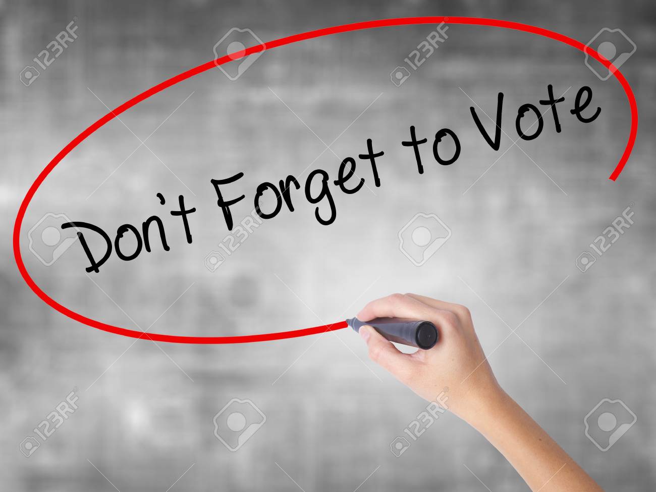 woman hand writing dont forget to vote with black marker over don t forget to vote