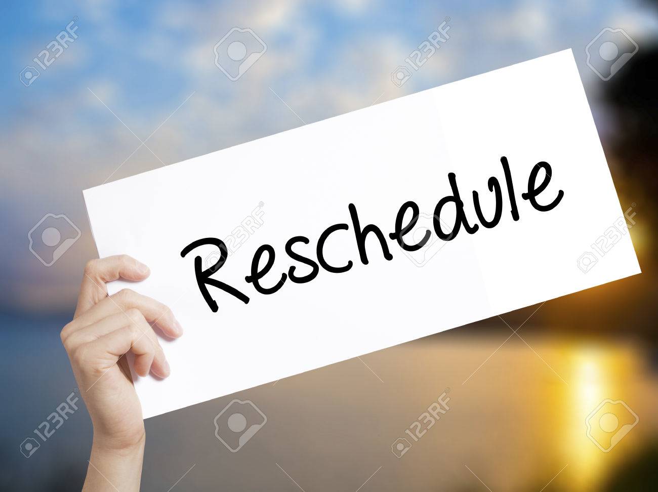 reschedule sign on white paper man hand holding paper with stock