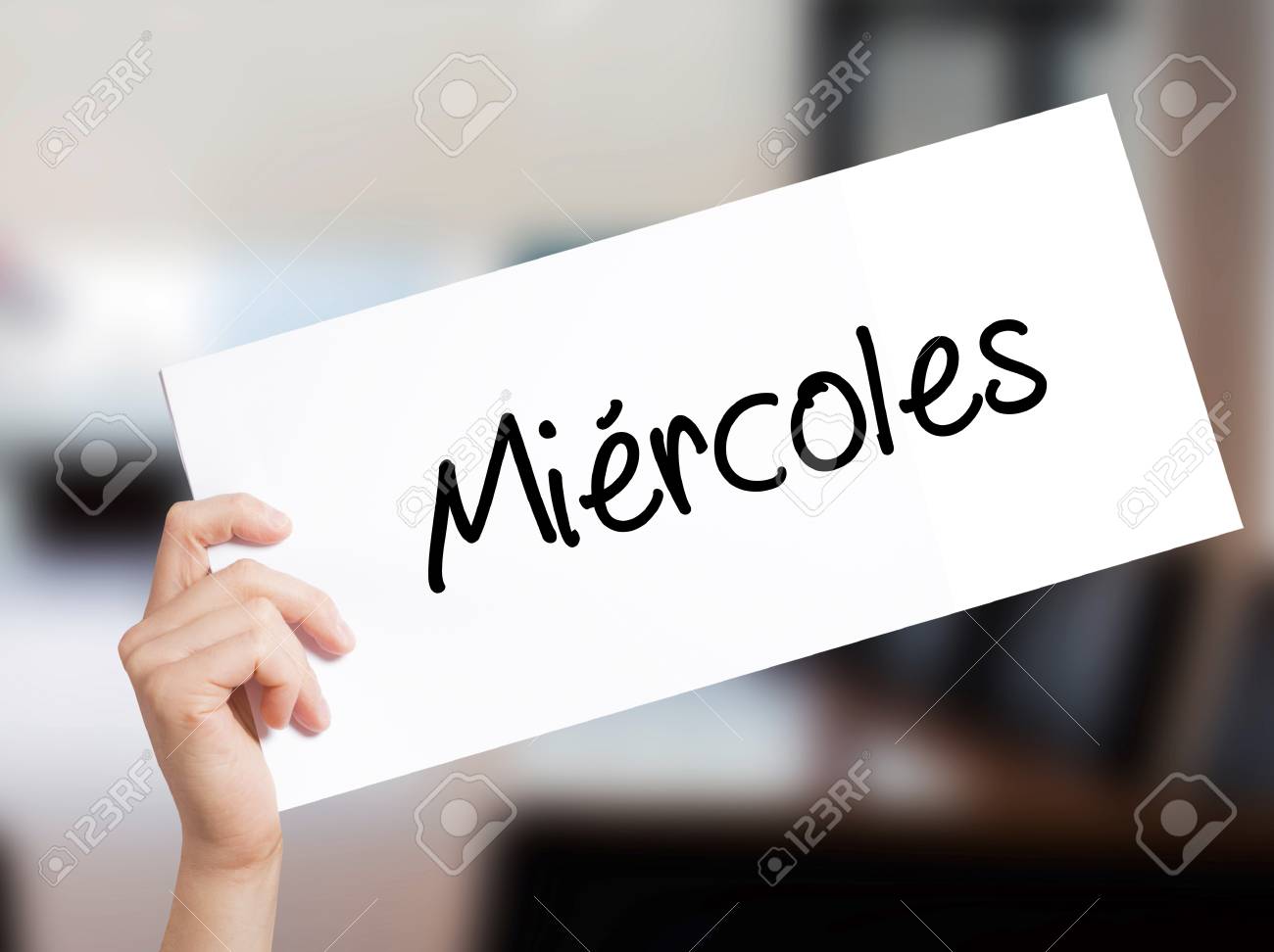 Miercoles (Wednesday In Spanish) Sign On White Paper. Man Hand Holding  Paper With Text. Isolated On Skyscraper Background. Business Concept. Stock  Photo Stock Photo, Picture and Royalty Free Image. Image 77689977.