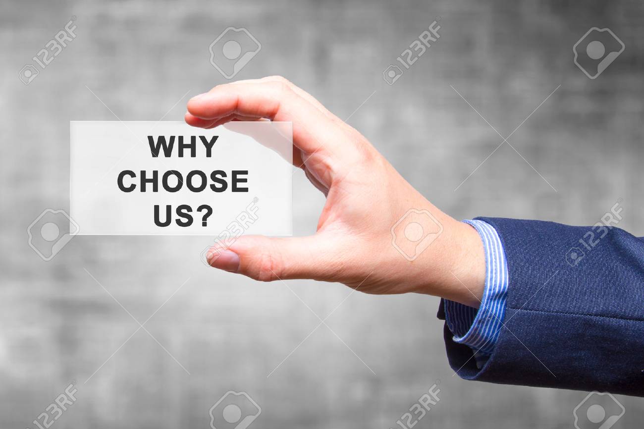 Businessman hand holding Why Choose Us? sign isolated on grey background. Business concept. Stock Photo - 81266214 Businessman hand holding Why Choose Us? sign isolated on grey background. Business concept. Stock Photo - 81266214