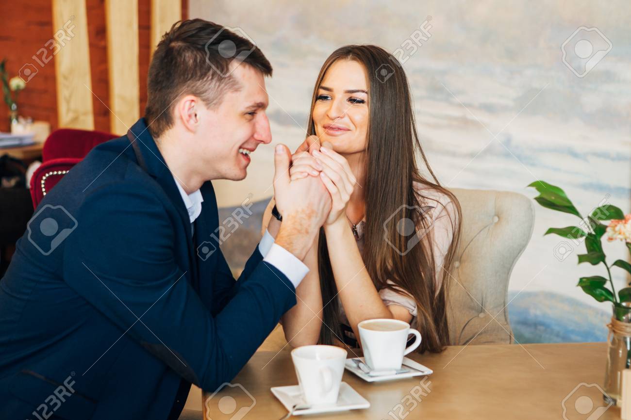 Happy young couple taking selfie with smart phone at cafe - 97567336 Happy young couple taking selfie with smart phone at cafe - 97567336