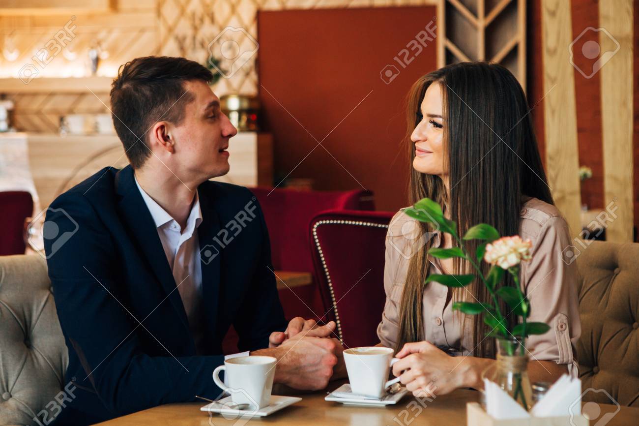 Happy young couple taking selfie with smart phone at cafe - 97567337 Happy young couple taking selfie with smart phone at cafe - 97567337