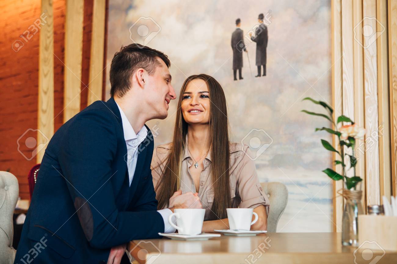 Happy young couple taking selfie with smart phone at cafe - 97567338 Happy young couple taking selfie with smart phone at cafe - 97567338